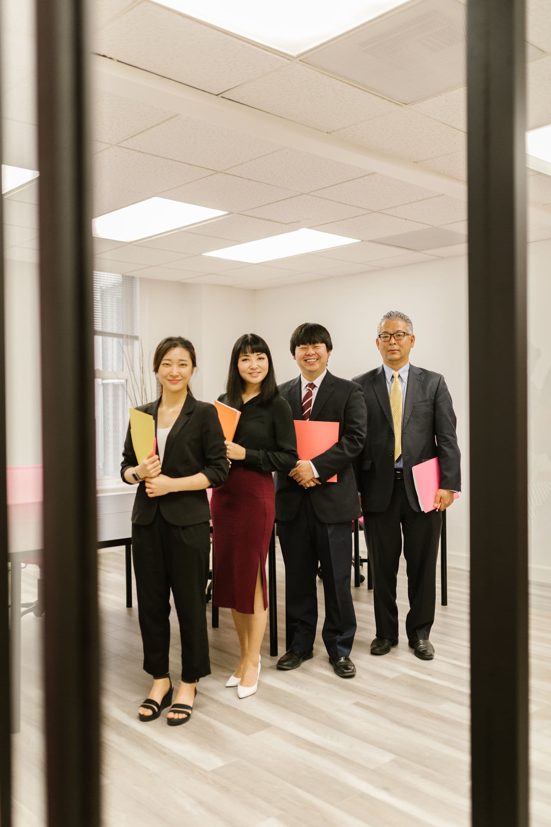 Japanese designers and strategists reviewing wireframes around a cedar table