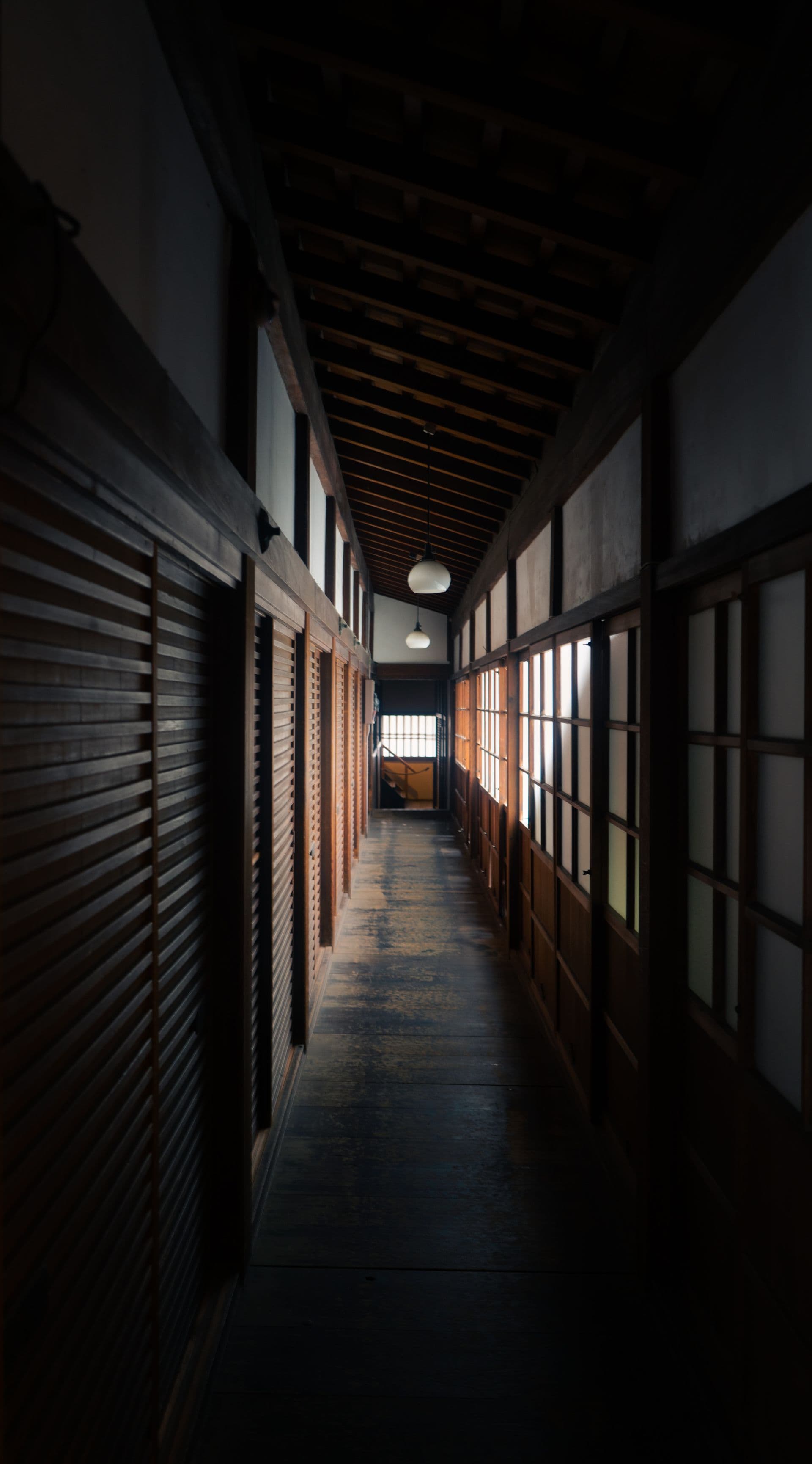 Traditional Japanese ryokan timber corridor with shoji screens